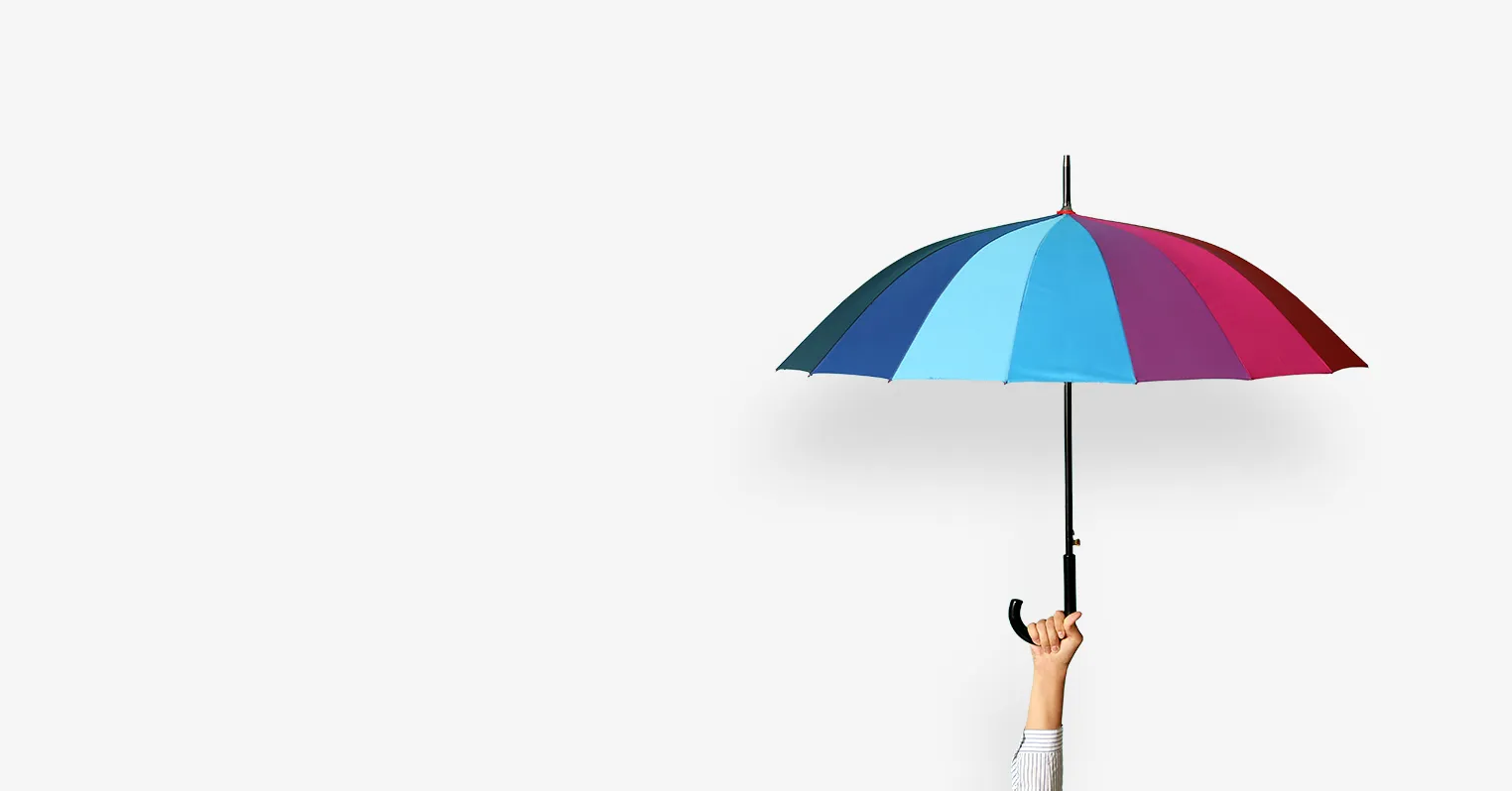 A hand holds up a multi-coloured umbrella