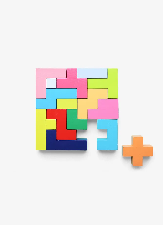 Coloured toy blocks with a missing plus-sized shape next to them