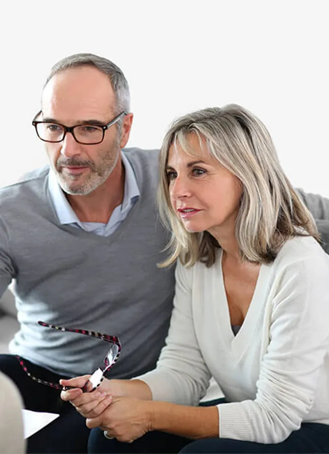 A photo depicting a man and a woman having an informal meeting with someone off camera