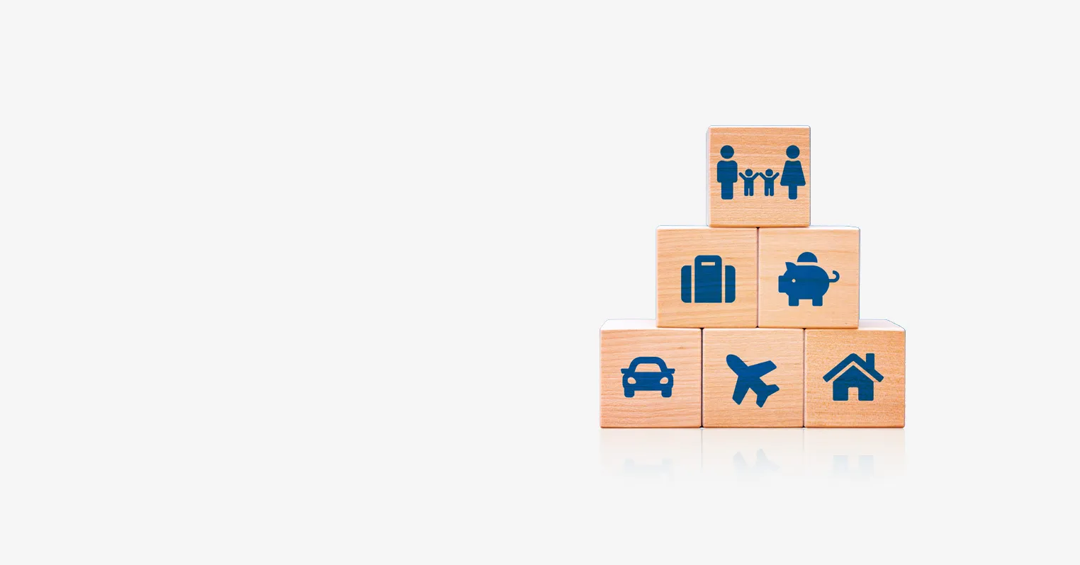 six wooden blocks stacked in a 3, 2, 1 formation, all of them have symbols depicting things such as a family, suitcase, car and house